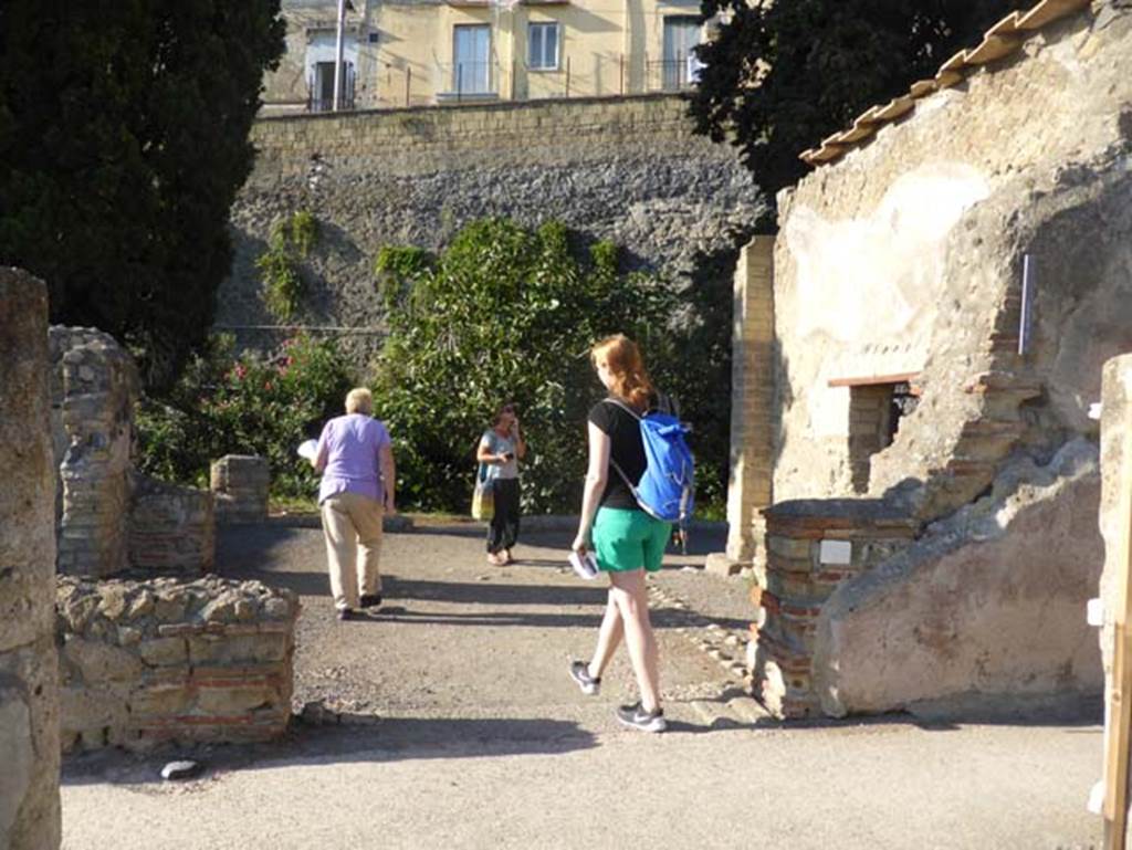 II.3 Herculaneum, September 2015. Looking west from doorway, which originally would have been the posticum (rear) doorway. The main part of the house is still buried under the adjacent Vico Mare.